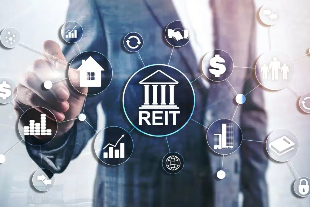 Man in suit standing behind an investment graphic